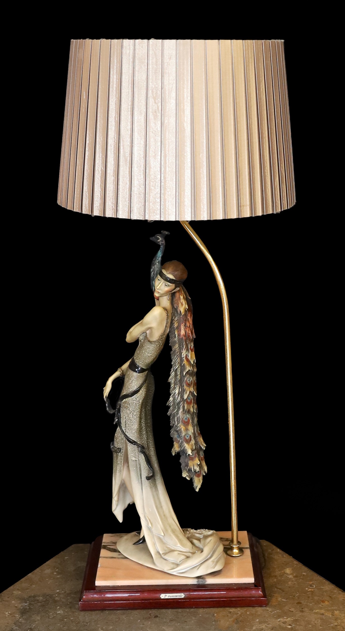 A 1980s Italian Giuseppe Armani lamp base, modelled with a resin lady holding a peacock, height 62cm, width of base 26cm